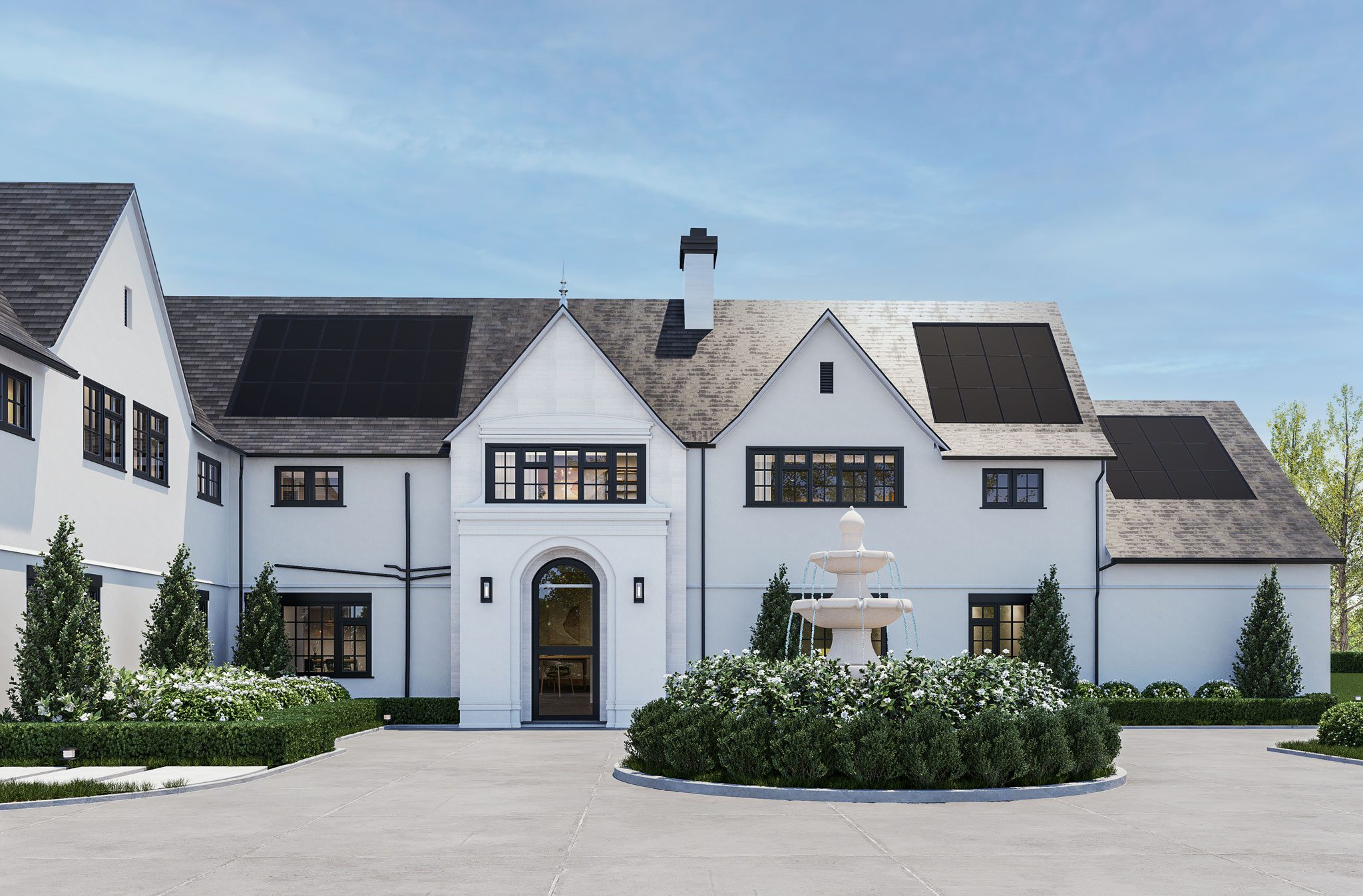 Large modern house with solar panels on the roof, featuring a central archway and a fountain in a circular driveway. Surrounded by greenery under a clear blue sky.