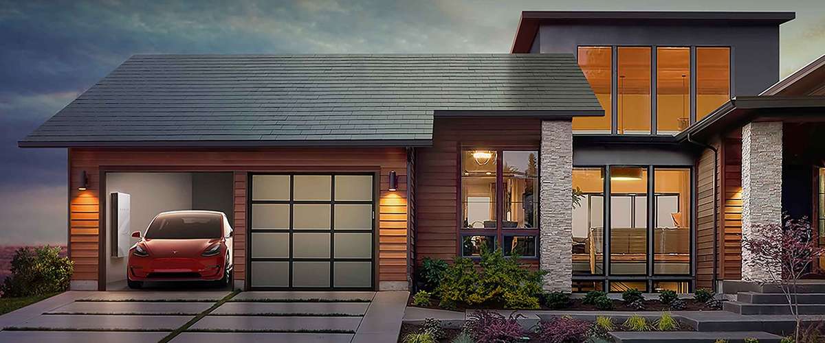 Modern house with a sleek design, large windows, and wood paneling. A red electric car is parked in the garage.